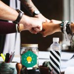 Circle of hands in a "fist bump"