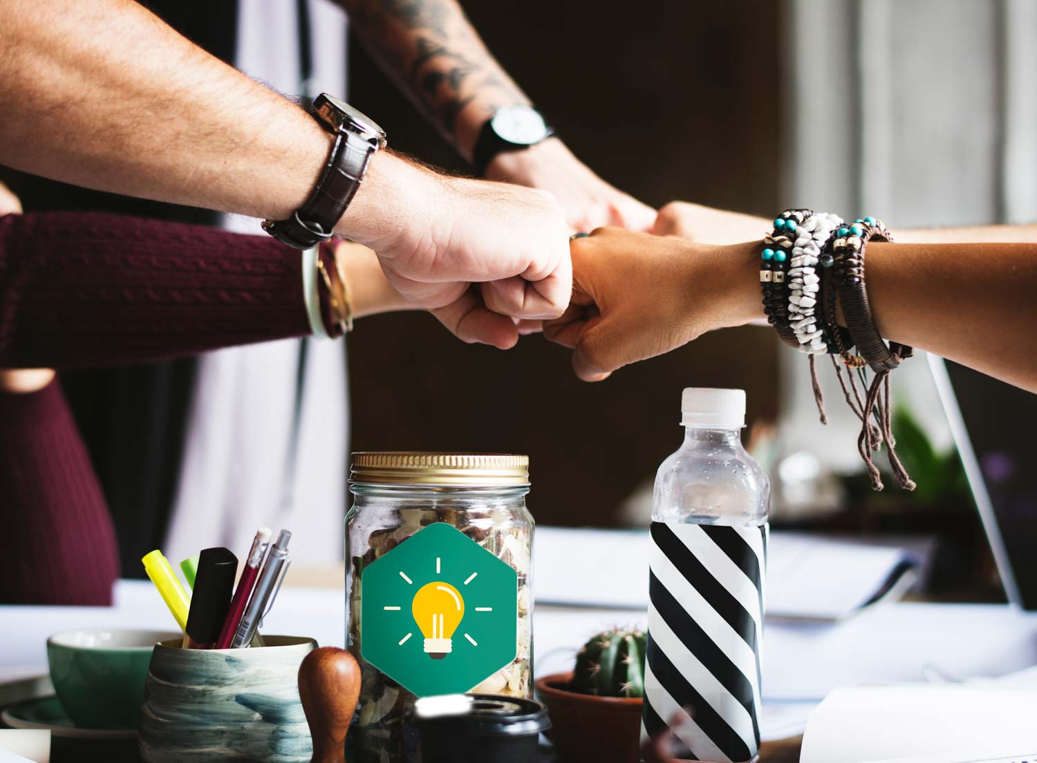 Circle of hands in a "fist bump"