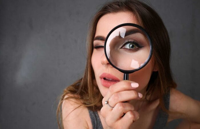 National Arts Fundraising School (NAFS) - 21st May 2025 Arts Fundraising Webinar - photo of woman holding a magnifying glass up to her eye.